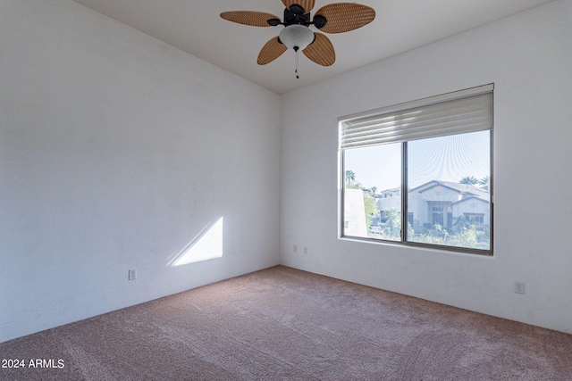 carpeted empty room featuring ceiling fan