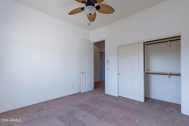 unfurnished bedroom with light colored carpet, ceiling fan, and a closet