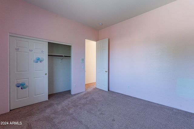 unfurnished bedroom with a closet and carpet flooring