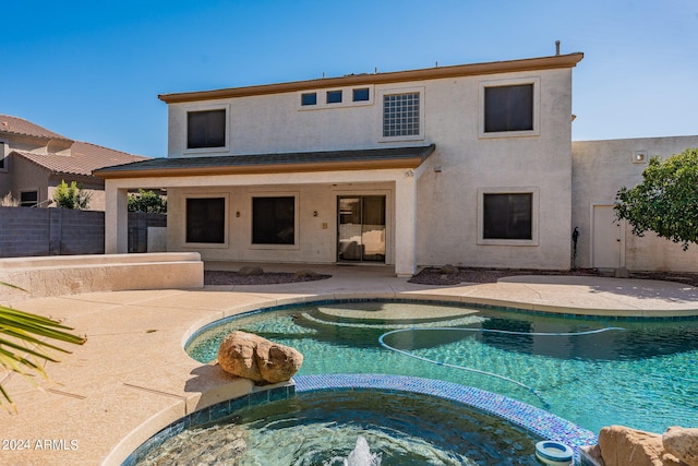 view of swimming pool with an in ground hot tub and a patio area