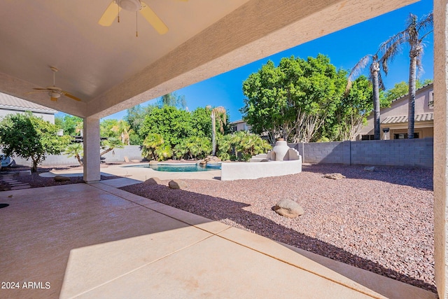 view of patio featuring a fenced in pool and ceiling fan