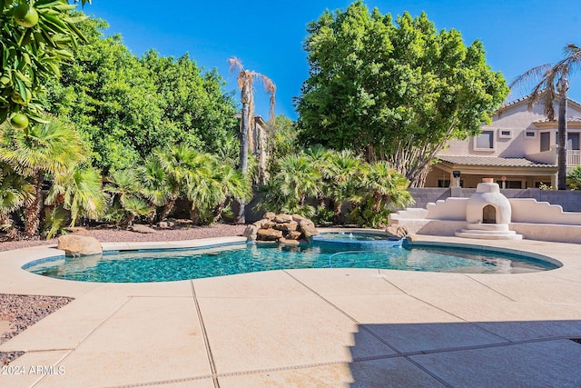 view of pool with a patio area and an in ground hot tub