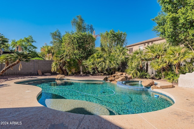 view of swimming pool with a patio and an in ground hot tub