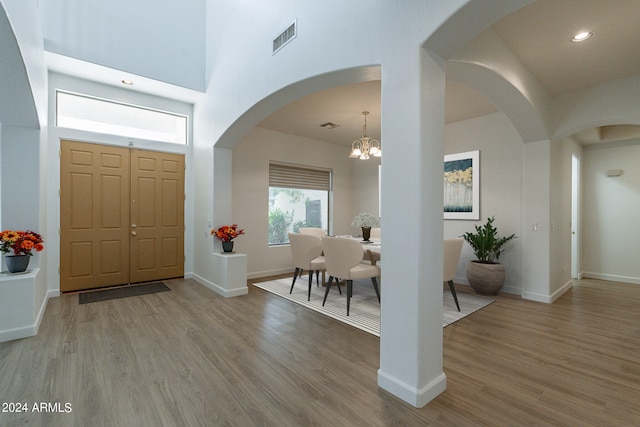 entryway featuring light hardwood / wood-style floors and an inviting chandelier