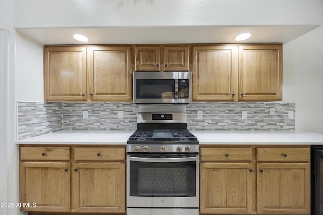 kitchen with light countertops, appliances with stainless steel finishes, and decorative backsplash