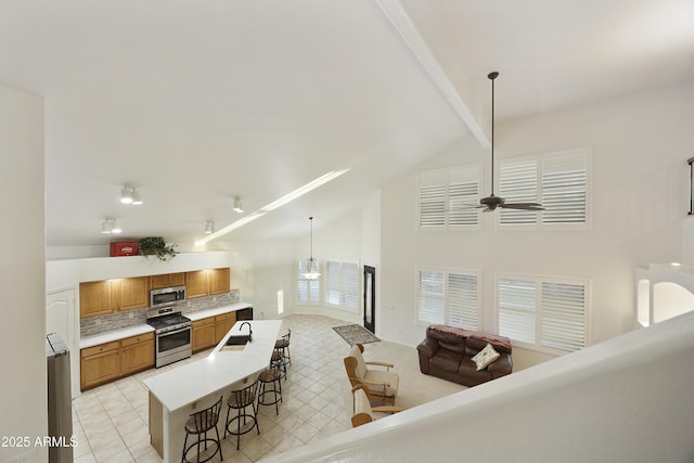 living area with a ceiling fan, light tile patterned flooring, high vaulted ceiling, and beamed ceiling