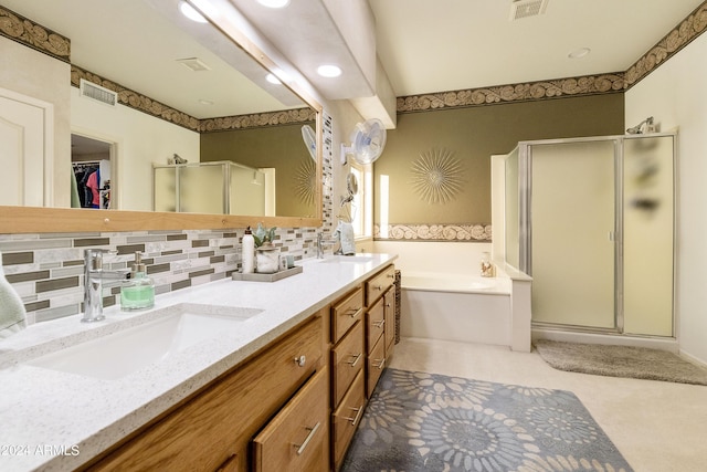 full bath with a sink, a shower stall, a garden tub, and visible vents