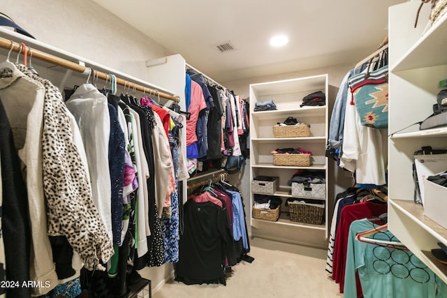 walk in closet with visible vents and carpet flooring