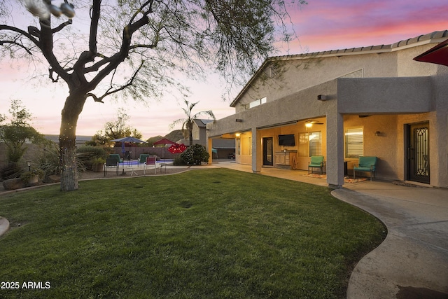 view of yard featuring fence and a patio