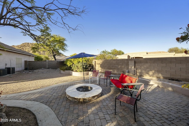 view of patio / terrace with a fenced backyard and an outdoor fire pit