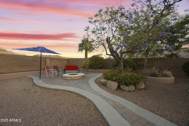 view of yard featuring a fenced backyard, a patio area, and an outdoor fire pit