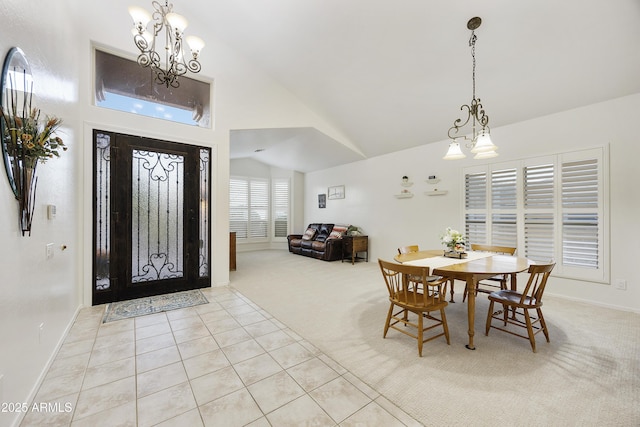 dining space with light colored carpet, an inviting chandelier, baseboards, light tile patterned floors, and lofted ceiling