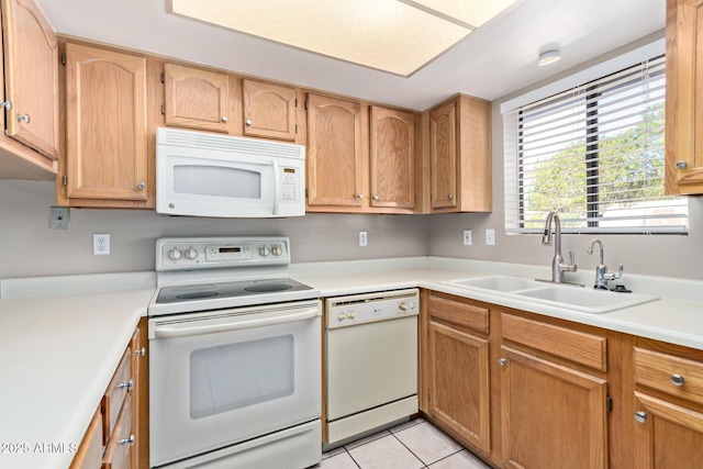 kitchen with white appliances, sink, and light tile patterned floors