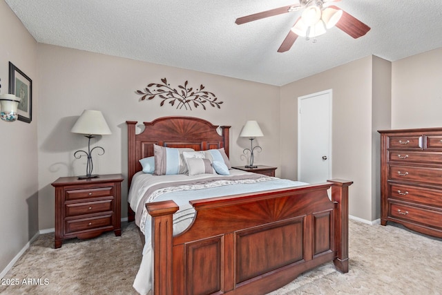 carpeted bedroom featuring ceiling fan and a textured ceiling