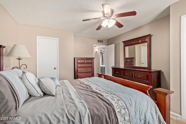 bedroom with a textured ceiling and ceiling fan