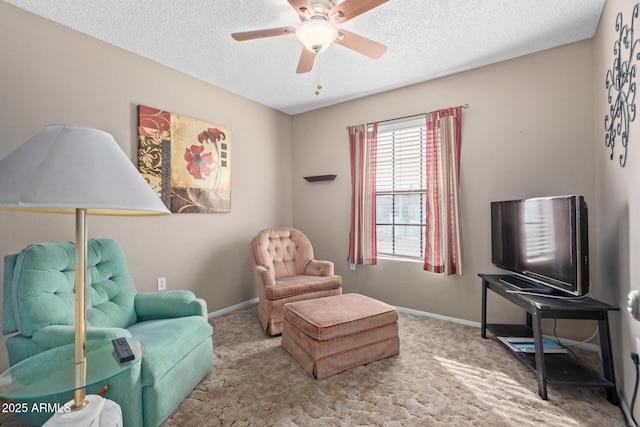 sitting room with ceiling fan, a textured ceiling, and carpet