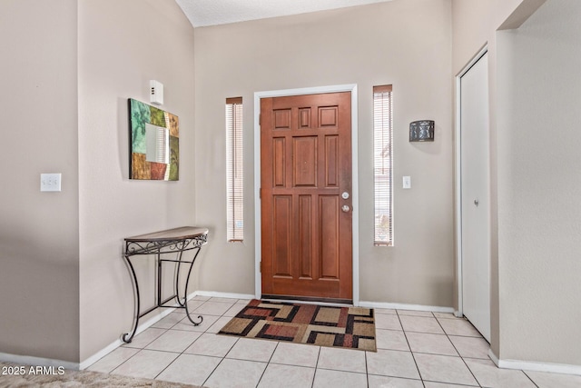 foyer entrance with light tile patterned flooring