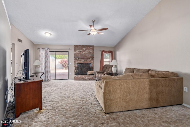 carpeted living room with lofted ceiling, a textured ceiling, a fireplace, and ceiling fan