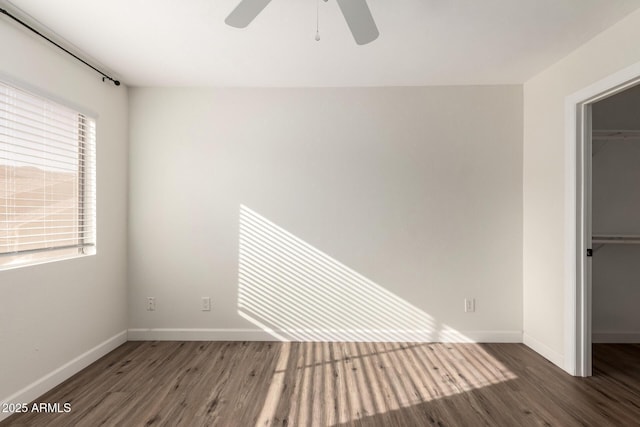 unfurnished room with ceiling fan and dark hardwood / wood-style flooring