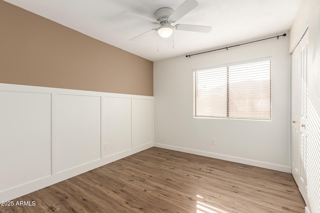 unfurnished room with ceiling fan and wood-type flooring