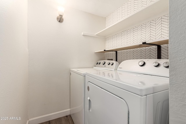 washroom featuring hardwood / wood-style flooring and washer and clothes dryer