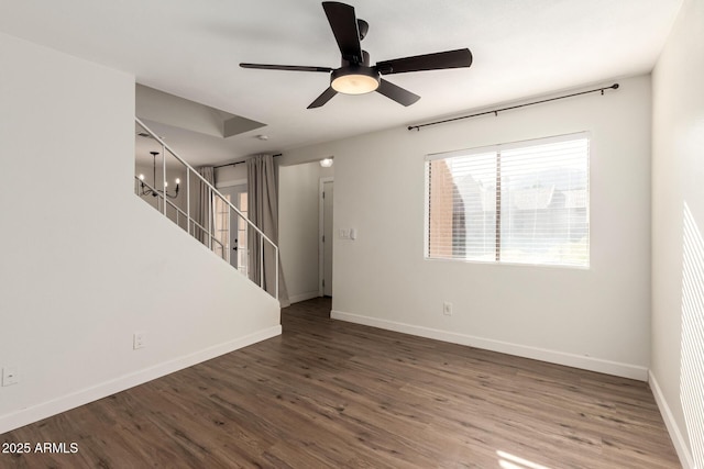 interior space with dark hardwood / wood-style flooring and ceiling fan with notable chandelier