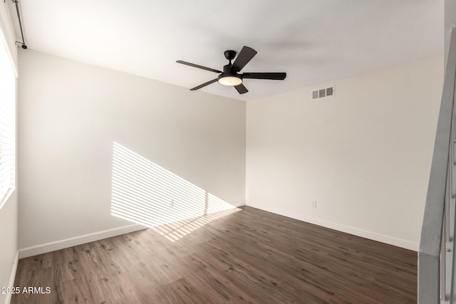 empty room featuring ceiling fan and dark hardwood / wood-style flooring