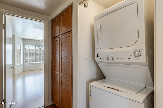 laundry room featuring stacked washing maching and dryer and laundry area