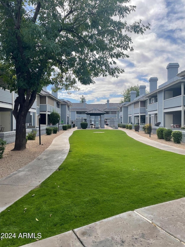 view of property's community featuring a residential view and a lawn