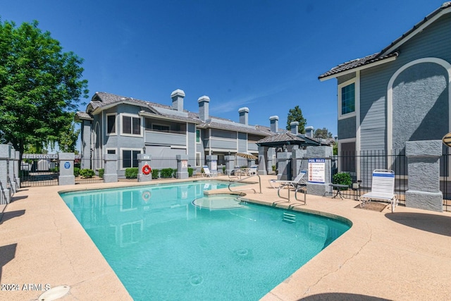 pool featuring a patio and fence