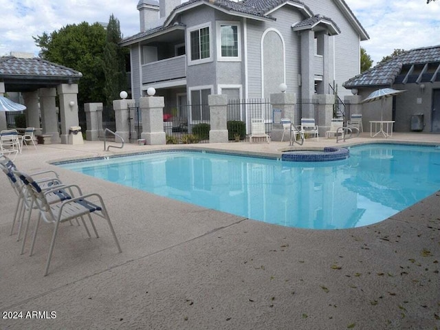 pool featuring a patio area and fence