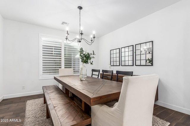 dining room with an inviting chandelier, visible vents, baseboards, and dark wood finished floors