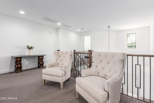 sitting room featuring recessed lighting, visible vents, and an upstairs landing