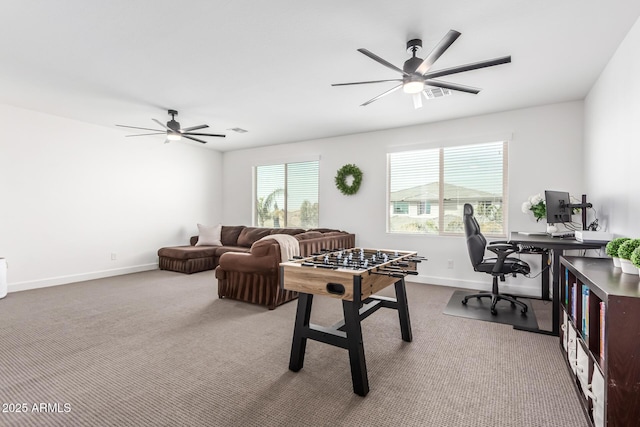 recreation room featuring carpet floors, ceiling fan, and baseboards