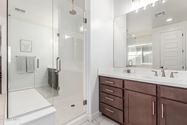 bathroom featuring marble finish floor, a stall shower, and visible vents