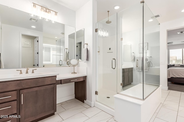 ensuite bathroom featuring marble finish floor, connected bathroom, vanity, and a shower stall