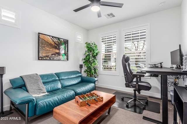 office space with visible vents, ceiling fan, and baseboards