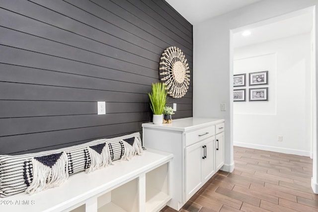 mudroom featuring light wood-style flooring and baseboards