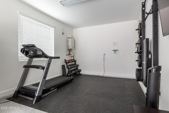 exercise room featuring water heater and baseboards