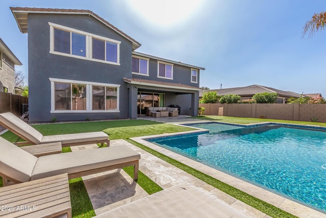 view of swimming pool with a fenced in pool, a fenced backyard, and an outdoor living space