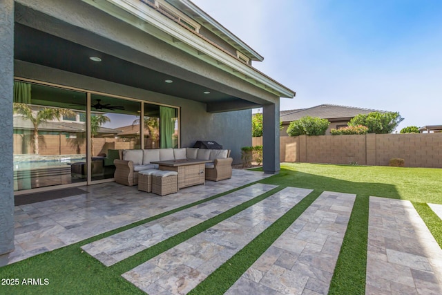 view of patio / terrace featuring ceiling fan, fence, and an outdoor living space