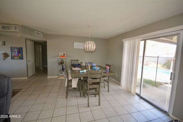 dining area featuring an inviting chandelier, light tile patterned floors, and visible vents