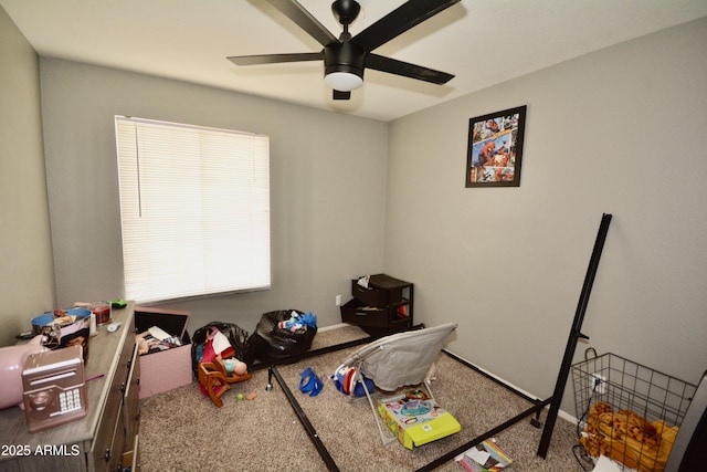 game room with carpet floors and a ceiling fan