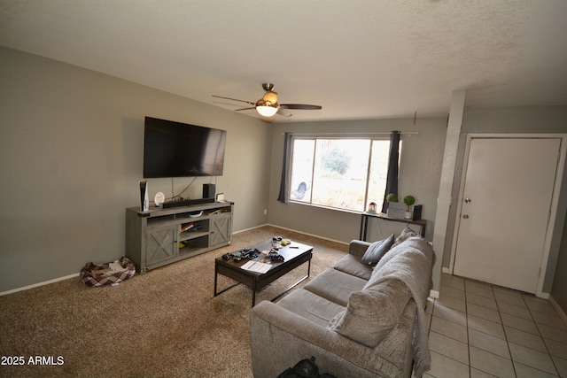 living room with tile patterned floors, baseboards, a ceiling fan, and carpet floors