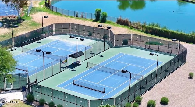 view of sport court featuring a water view