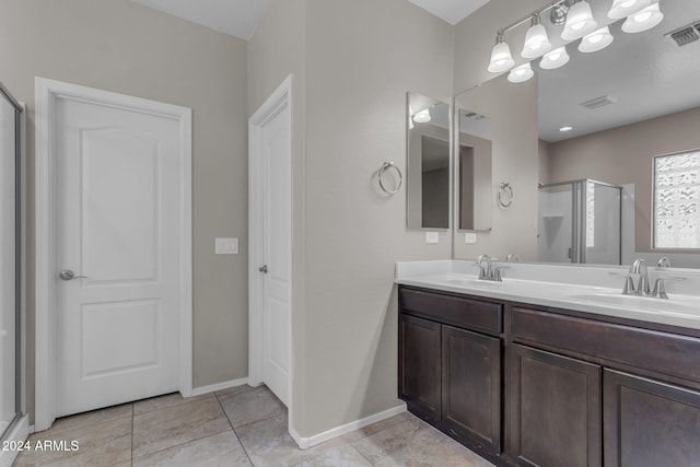 bathroom with tile patterned floors, vanity, and a shower with shower door