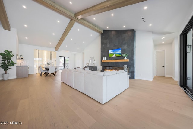 6126 E Charter Oak Rd, Scottsdale, AZ 85254 - living area with beam ceiling, light wood finished floors, a fireplace, high vaulted ceiling, and recessed lighting