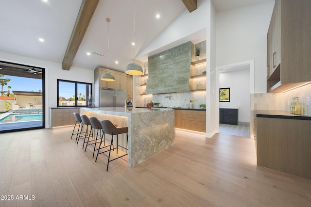 6126 E Charter Oak Rd, Scottsdale, AZ 85254 - kitchen featuring built in refrigerator, wall chimney exhaust hood, light wood-type flooring, beam ceiling, and modern cabinets