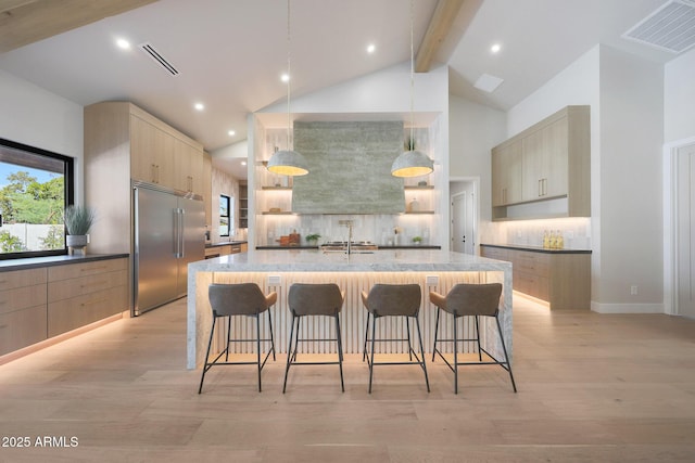 6126 E Charter Oak Rd, Scottsdale, AZ 85254 - kitchen with built in fridge, wall chimney range hood, light brown cabinets, high vaulted ceiling, and beamed ceiling