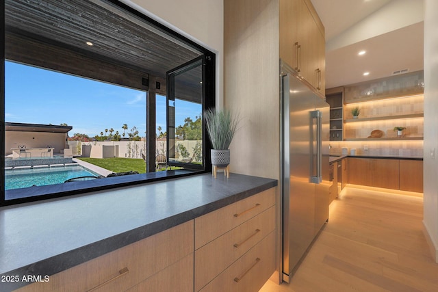 6126 E Charter Oak Rd, Scottsdale, AZ 85254 - kitchen featuring high quality fridge, light wood-style floors, light brown cabinets, recessed lighting, and dark countertops